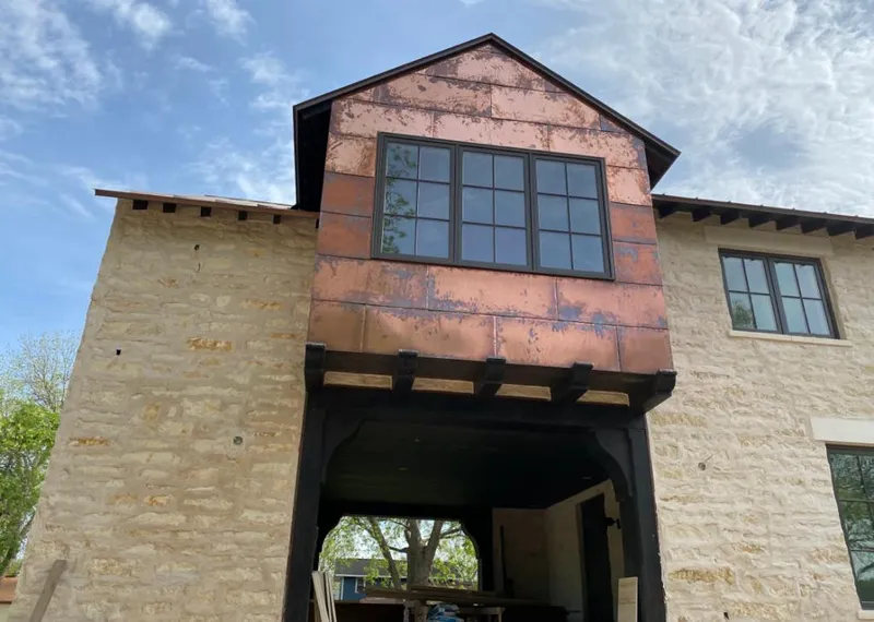 Copper metal panel facade on a stone building for Skylight Installation in McHenry