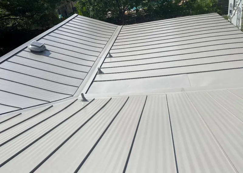 Solar attic fan installed on a metal roof for Roof Ventilation in McHenry
